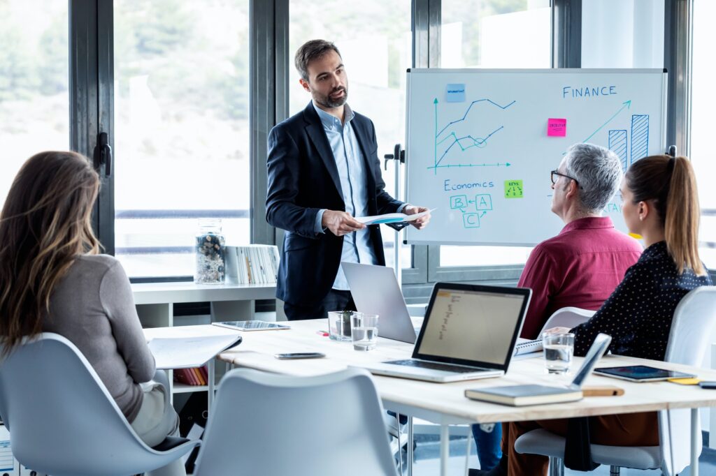 handsome businessman explaining a project to his colleagues on coworking place